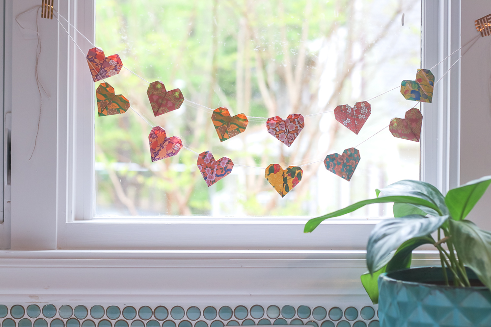 origami heart garland on window